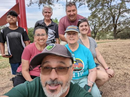 Herb (KM6JBI), Maria (KM6JBI /XYL), Theta (WA6EWF), Gerry (WA6E), and Thomas (KN6MJB) posing for a selfie in the park.