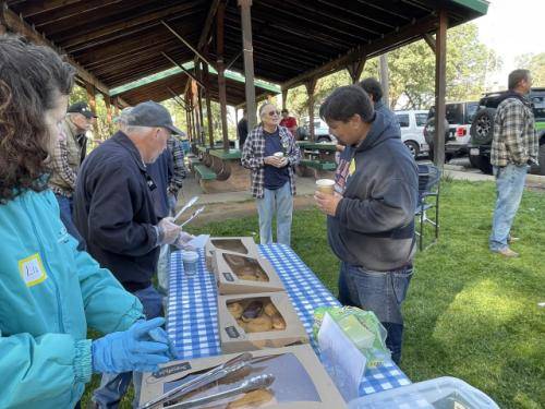 Greydon (KC6SLE) working with Chip (KM6MDF) to find a donut with just the right amount of rainbow sprinkles.